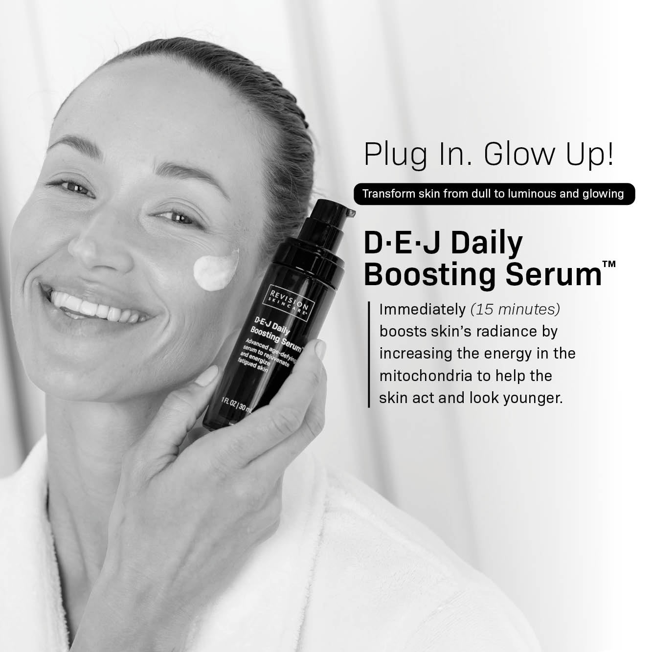 A smiling woman in a white robe applies cream to her cheek while holding a bottle of Revision Skincare’s D·E·J Daily Boosting Serum® 2 fl oz, an anti-aging serum that enhances skin radiance and firmness.