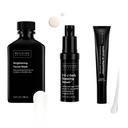 The Glow Essentials Gift Set by Revision Skincare features three products in sleek black packaging with swatches, designed to brighten and rejuvenate your skin.