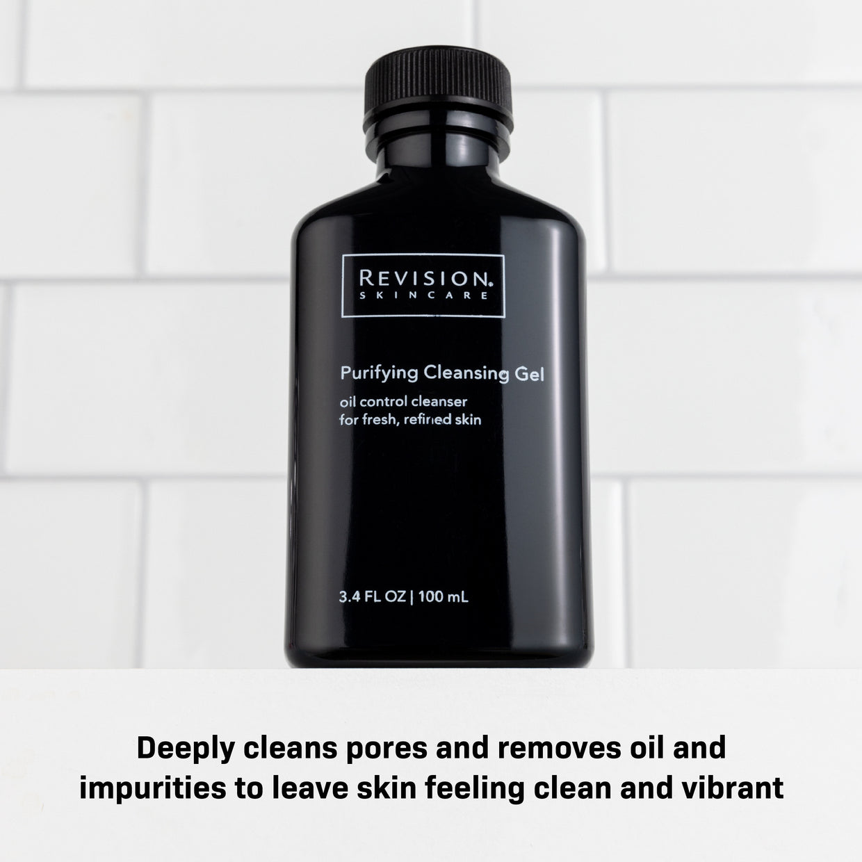 A black bottle of Revision Skincare Purifying Cleansing Gel 3.4 fl oz rests on a white surface with tile background. It deeply cleans pores, removes oil and impurities—perfect for oily skin and leaves complexion looking vibrant.