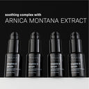 Four black bottles of Revision Skincare Vitamin K Serum 0.5 fl oz are arranged in a row on a dark surface. Text above highlights soothing Arnica Montana Extract and antioxidant benefits.