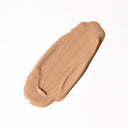 A smear of Revision Skincare Intellishade® Original, an anti-aging tinted moisturizer with broad-spectrum SPF 45, is spread on a white background.