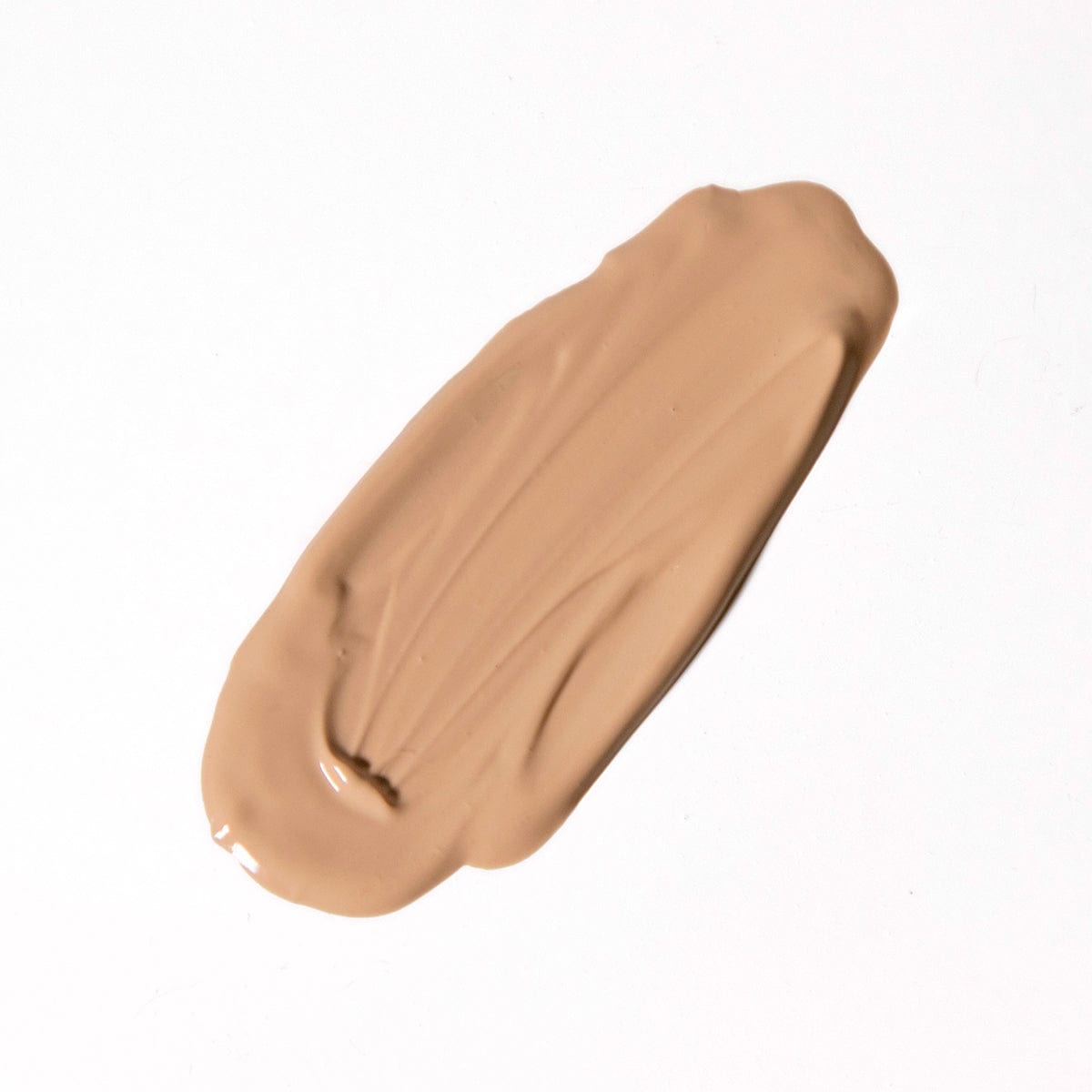 A smear of Revision Skincare Intellishade® Original, an anti-aging tinted moisturizer with broad-spectrum SPF 45, is spread on a white background.