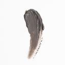 A thick, dark gray brushstroke of Revision Skincare Pore Purifying Clay Mask is smeared on a white background, resembling a paint swatch.