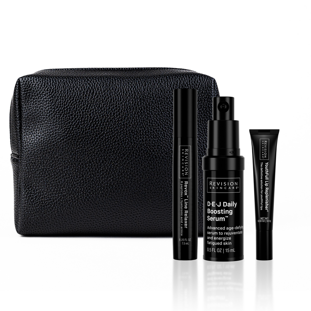 A black textured cosmetic bag sits behind three Revision Skincare Injection Perfection Regimen products: Revox Line Relaxer tube, D·E·J Daily Boosting Serum bottle, and YouthFull Lip Replenisher tube.