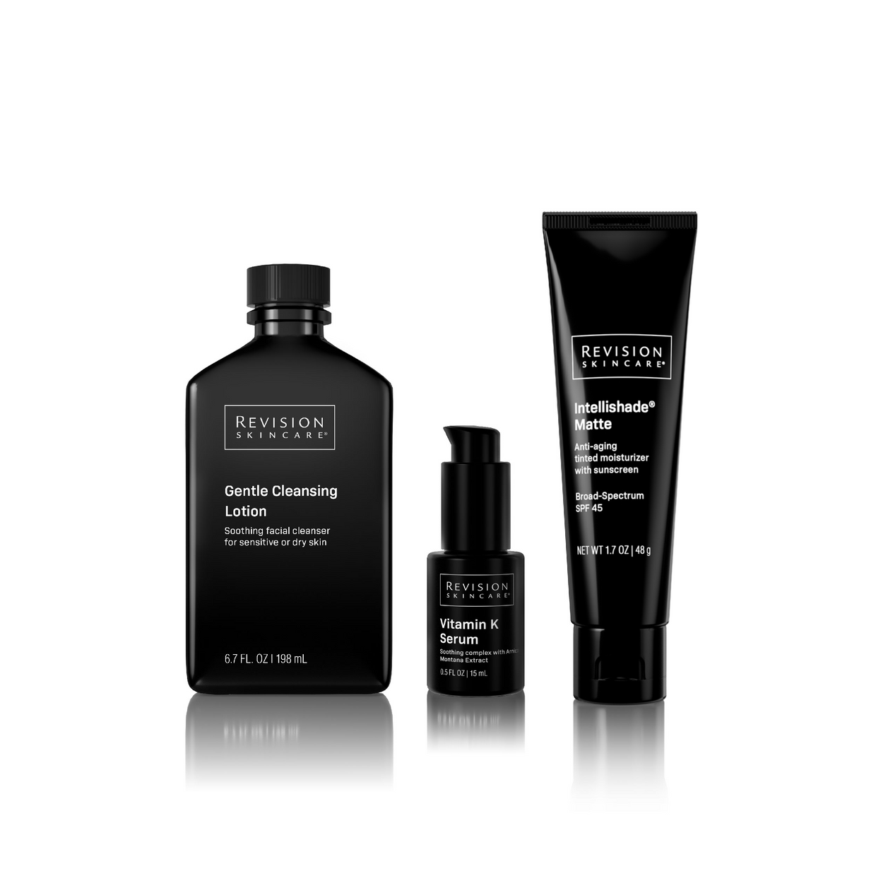 Three black bottles of Revision Skincare’s Anti-Redness Basics Full-Size Regimen are arranged side by side on a white background, with a subtle reflection below.