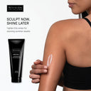 Someone applies a white cream to their upper arm beside a black BodiContour™ tube from Revision Skincare. Text: SCULPT NOW, SHINE LATER. Shape your body with iFirm® Technology—tighten this winter for stunning summer results!.