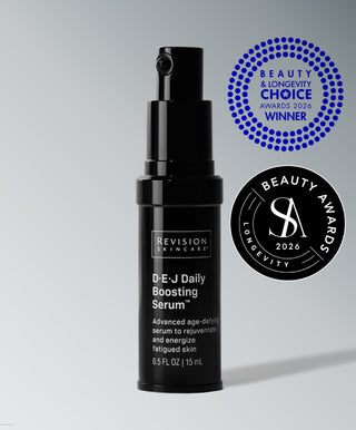 A black bottle of D·E·J Daily Boosting Serum® by Revision Skincare, an anti-aging serum that energizes skin cells, shown with two award logos on a gray background.