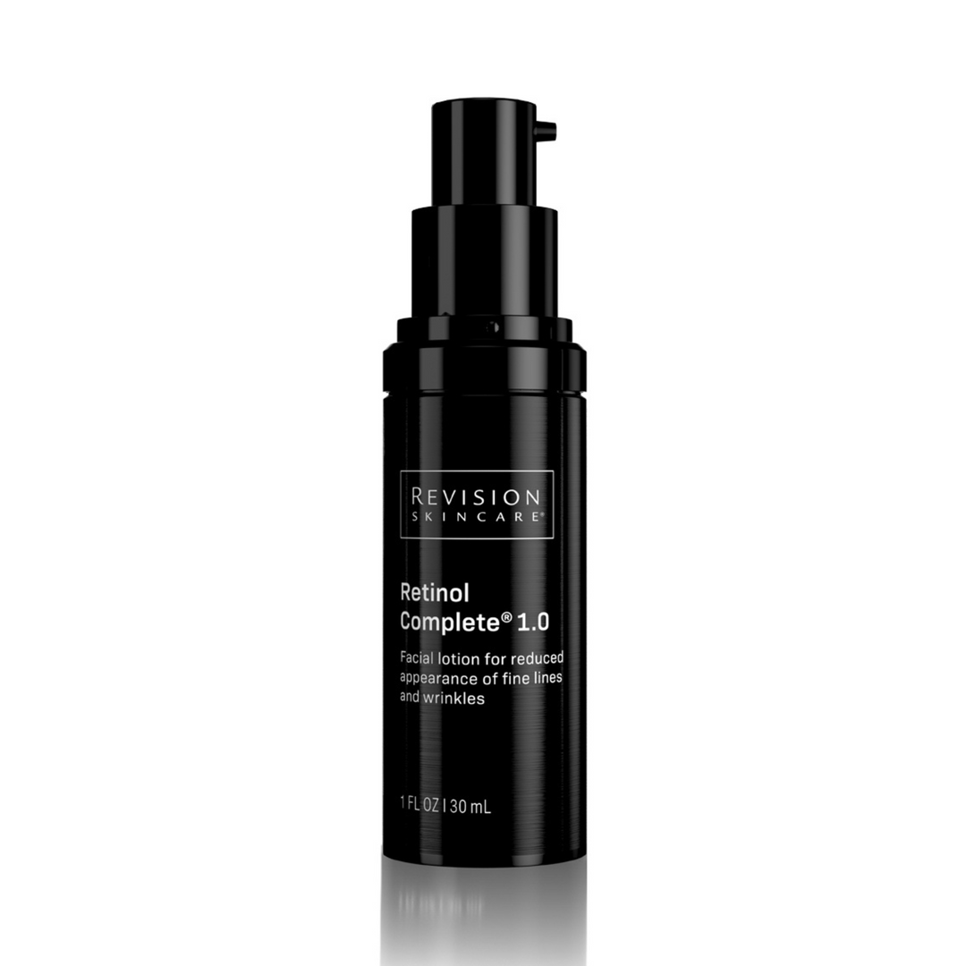 A 1 fl oz black bottle of Revision Skincare Retinol Complete® 1.0 anti-aging serum with pump dispenser, designed to reduce fine lines, wrinkles, and brighten skin.