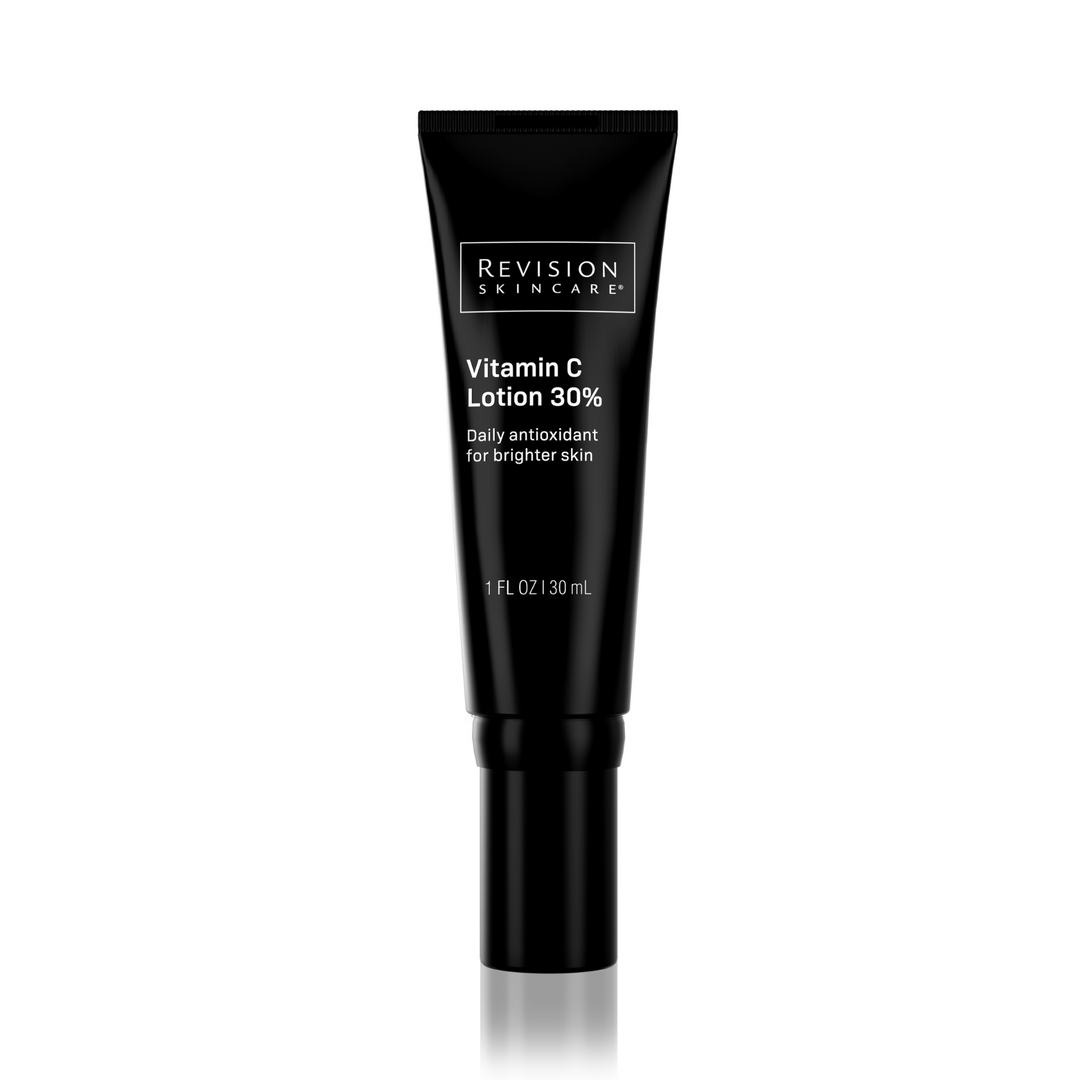 A black tube of Revision Skincare Vitamin C Lotion stands upright on a white background. The 1 fl oz (30 mL) moisturizer features THD Ascorbate, offering daily antioxidant benefits for brighter skin.