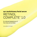 A yellow serum with black text promotes Revision Skincare’s Retinol Complete® 1.0 anti-aging serum, designed to reduce fine lines and wrinkles. A 0.5 strength is also available to help brighten skin.
