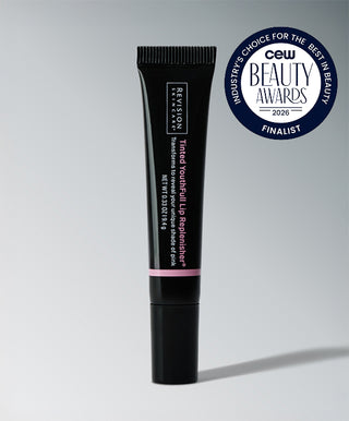 A tube of Revision Skincare Tinted YouthFull Lip Replenisher® stands upright with a blue CEW Beauty Awards 2026 finalist badge in the top right corner.
