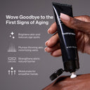 A hand squeezes Revision Skincare YouthFull Hands™ onto another hand. Text and icons highlight key benefits: brightens skin, plumps thinning skin, strengthens the skin barrier, and deeply moisturizes for smoother hands.