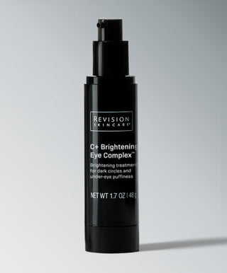 A black cylindrical pump bottle labeled Revision Skincare C+ Brightening Eye Complex™, a Vitamin C formula for reducing dark circles and puffiness; net weight 1.7 oz.