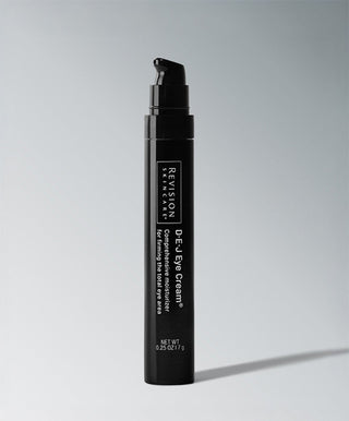 A black pump bottle of Revision Skincare D·E·J Eye Cream®—a firming eye treatment—stands upright against a light gray background, displaying the product label on the front.