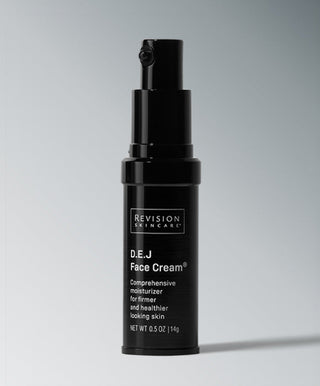 A black bottle of Revision Skincare D·E·J Face Cream® with a pump stands upright on a gray background. The label highlights this anti-aging moisturizer that promotes firmer, healthier-looking skin.