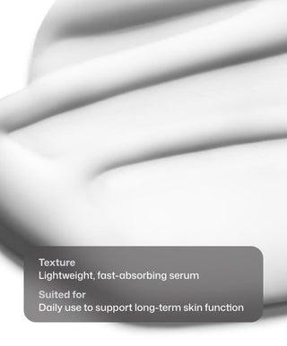 A close-up of Revision Skincare’s D·E·J Daily Boosting Serum® reveals a smooth, lightweight texture. Text overlay: Texture: Fast-absorbing serum. Suited for: Daily use to boost cellular energy and support skin function long-term.