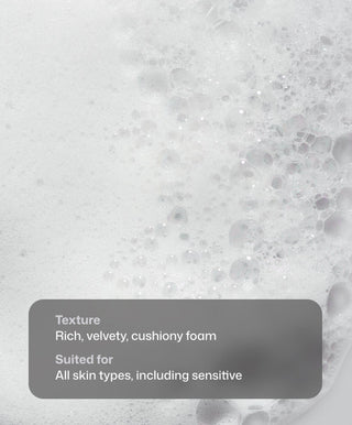 Close-up of dense, white foam bubbles showcases the cushiony texture of Revision Skincare's Gentle Foaming Cleanser, emphasizing its gentle formula and suitability for all skin types, even sensitive.