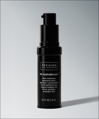 A black bottle of Revision Skincare HA HydraSerum+™ with a pump, 0.5 fl oz (15 mL). This serum hydrates and smooths skin with hyaluronic acid, peptides, and antioxidants for anti-aging benefits.