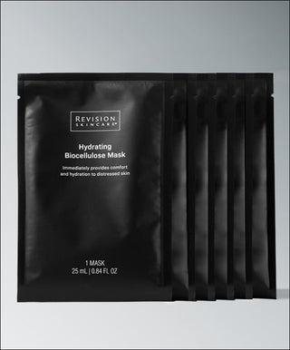Five black Revision Skincare Hydrating Biocellulose Mask packets stand upright, one in front and four behind, against a gradient background—perfect for soothing hydration after procedures.