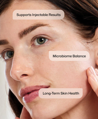 A close-up of a woman with clear skin touching her cheek. Overlaid text: Injection Perfection Full-Size Regimen by Revision Skincare supports injectable results, firmer skin, and long-term skin health.