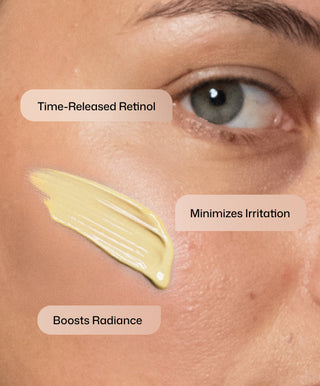 Close-up of a person’s face with a cream swatch and three text labels: Time-Released Retinol, Minimizes Irritation, Boosts Radiance—highlighting Revision Skincare’s Retinol Complete® 1.0 anti-aging serum that reduces fine lines and wrinkles.
