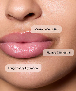 Close-up of glossy, hydrated lips labeled: Custom-Color Tint, Plumps & Smooths, and Long-Lasting Hydration—showcasing Revision Skincare Tinted YouthFull Lip Replenisher®, an age-defying lip treatment and advanced volumizer on smooth skin.