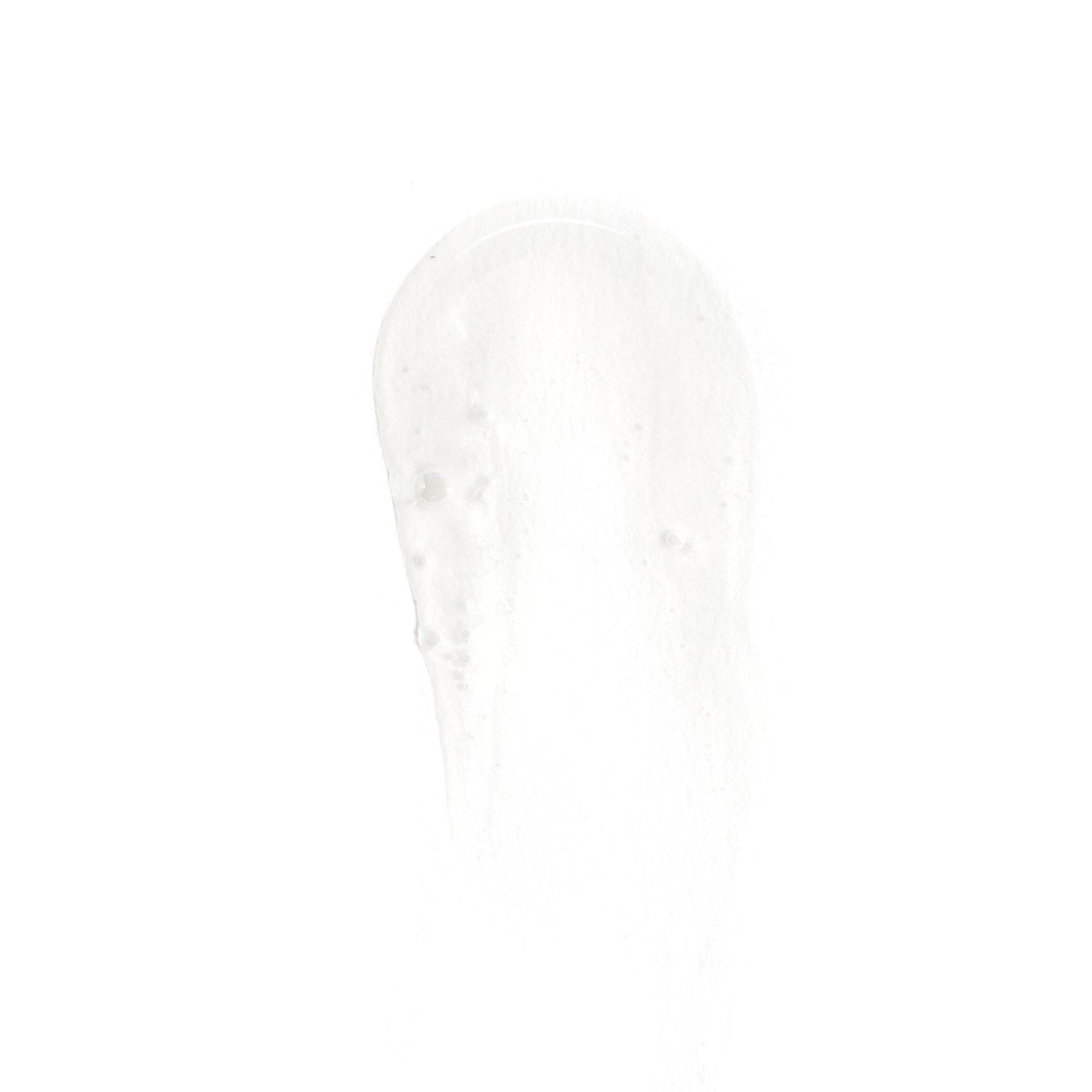A small, clear drop of Revision Skincare Brightening Facial Wash gel is smeared on a white background, revealing its smooth, translucent texture with tiny bubbles inside.