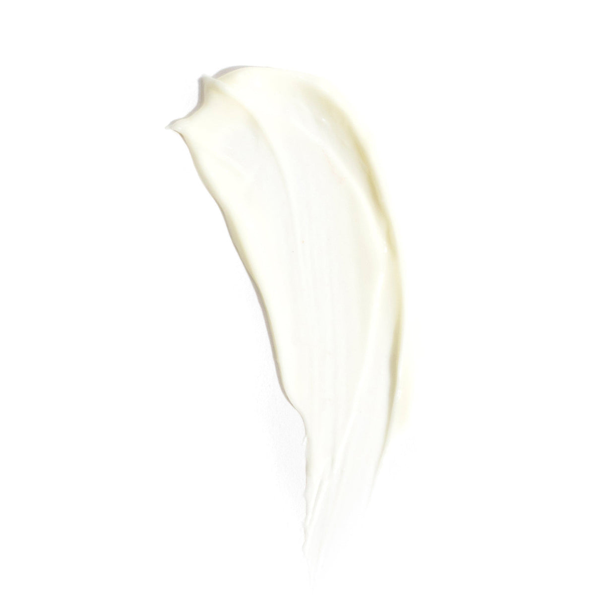 A creamy smear of Revision Skincare’s D·E·J Night Face Cream® is spread in an elongated, curved shape on a white background.